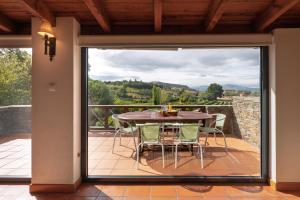 a glass door leading to a patio with a table and chairs at Casa de Sao Miguel Douro in Armamar