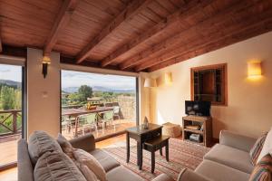a living room with a couch and a table at Casa de Sao Miguel Douro in Armamar