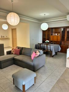 a living room with a couch and a table at Theseus beach with sea and sunrise view in Heraklio Town