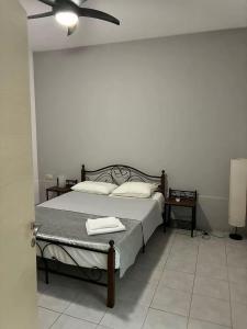 a bedroom with a bed with two towels on it at Theseus beach with sea and sunrise view in Heraklio Town +2 photos