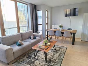 a living room with a couch and a table at Résidence des sables in Brussels
