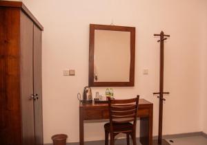 a room with a wooden desk with a mirror and a chair at Scenic View - Ella in Ella