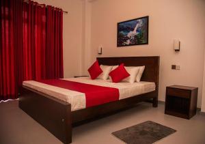 a bedroom with a large bed with red curtains at Scenic View - Ella in Ella