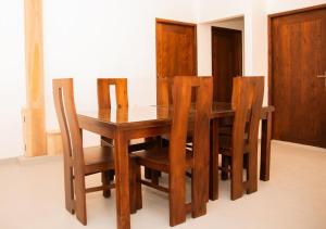 a wooden dining room table with four wooden chairs at Scenic View - Ella in Ella