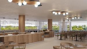 a restaurant with wooden tables and chairs and windows at Cabot Cala Ferrera in Cala d´Or