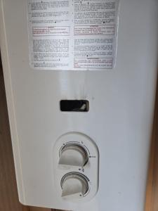 a white washing machine with a paper on it at Dunepark in Nieuwpoort