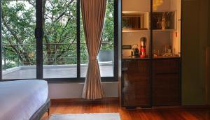 a bedroom with a bed and a large window at Stanley Revelation in Attigundi