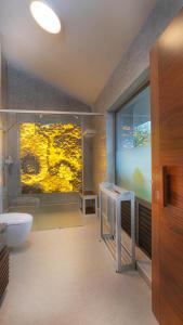 a bathroom with a sink and a toilet at Stanley Revelation in Attigundi +24 photos