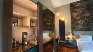 a hotel room with a bed and a table with a blender at Stanley Revelation in Attigundi