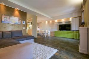 a living room with a couch and a tv and a table at Villetta dei Pascoli in Baveno +29 photos