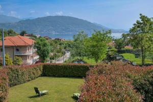 a yard with a chair and a view of the water at Villetta dei Pascoli in Baveno +29 photos