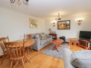 a living room with a couch and a table at Low Dow Crag in Coniston
