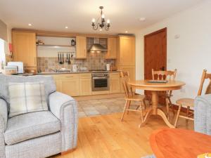 a kitchen and dining room with a table and chairs at Low Dow Crag in Coniston