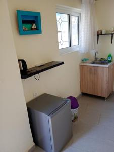 a small kitchen with a sink and a refrigerator at Stefanos Garden3 in Arménoi +6 photos
