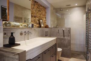 a bathroom with a sink and a toilet at Kel Domènech Luxury Apartment in Besalú +37 photos