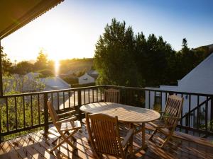a patio with a table and chairs on a balcony at Adderley House Guest Accommodation in Robertson