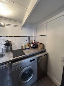 a laundry room with a washing machine and a sink at Charming cozy studio in Montpellier