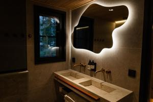 a bathroom with a sink and a mirror at Vaattunki Wilderness Resort in Rovaniemi +41 photos