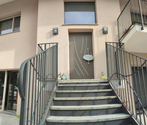 a set of stairs leading up to the door of a building at Casa del gelso in Canale