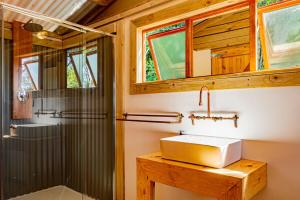 a bathroom with a sink and a shower at AfriCamps at White Elephant Safaris in Pongola Game Reserve