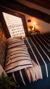 a bed in a room with a window at Piccola casa vacanze - Small vacation house in Porto Valtravaglia