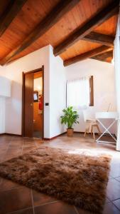 a living room with a table and a rug at Piccola casa vacanze - Small vacation house in Porto Valtravaglia