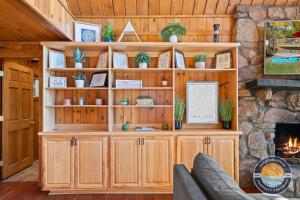 a large wooden cabinet with plants on it in a living room at 405 Waldeck Dr in Twin Lakes