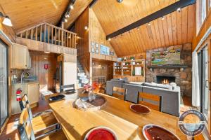 a living room with a table and a fireplace at 405 Waldeck Dr in Twin Lakes