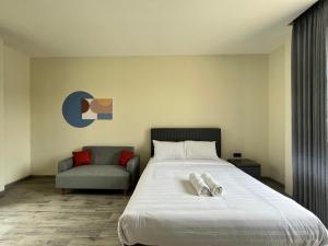 a bedroom with a large bed and a chair at Cove Legacy in Jakarta +16 photos