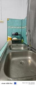 a stainless steel sink in a small kitchen at Jatuporn in Betong
