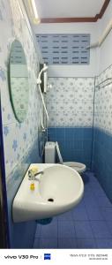 a bathroom with a sink and a toilet at Jatuporn in Betong