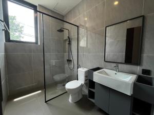 a bathroom with a toilet and a sink and a shower at Cove Legacy in Jakarta