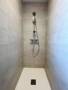 un baño con ducha con cabezal de ducha en Parenthèse à l'Oasis, en Ploërmel