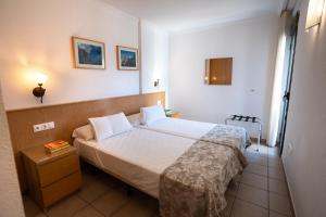 Postel nebo postele na pokoji v ubytování APARTAMENTOS SERRELLA - Rural Guadalest