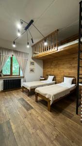 a large room with two beds and a staircase at кемпінг-парк Метеорит in Orlovshchina