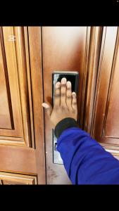 a persons hand on a door of a refrigerator at Shalom Apartment in Lusaka +3 photos