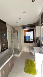 a bathroom with a tub and a shower and a sink at Willa Sulejowka in Poronin