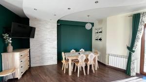a dining room with a table and chairs at Willa Sulejowka in Poronin +163 photos