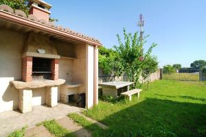 a patio with a picnic table and a bench in a yard at Adosados en Vilanova de Arousa in Villanueva de Arosa