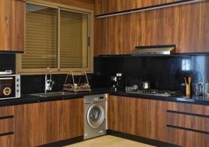 a kitchen with a stove and a washing machine at Villa with Private Pool in Marrakech - Dar Mazar in Oubadine