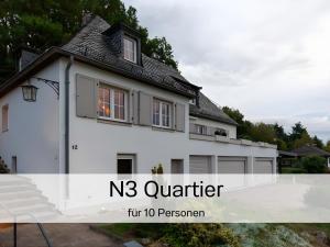 a white house with the words quartier on it at N3 Quartier in Kall