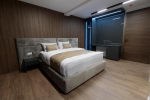 Ένα ή περισσότερα κρεβάτια σε δωμάτιο στο Velura Hotel & Spa