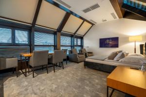 a bedroom with a bed and a table and chairs at Great Polonia The Granary La Suite Hotel in Wrocław +104 photos