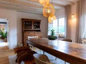 a dining room with a wooden table and chairs at N3 Quartier in Kall