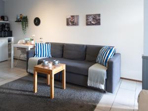 a living room with a couch and a table at Lucy's Apartment in Borgarnes