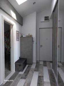 a hallway with a door and a stool in a room at New Grey in Novi Beograd +11 photos