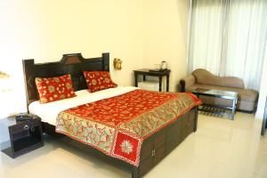 a bedroom with a large bed with red pillows at Hotel Rangbhawan Kumbhalgarh in Kelwāra +26 photos