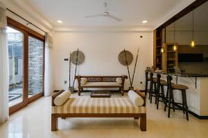 a living room with a bench and a table at Sapphire Escape - Private Villa in Ambalangoda in Ambalangoda