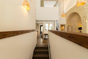 a hallway of a house with white walls and stairs at Musart Entre Artes in Jerez de la Frontera +34 photos