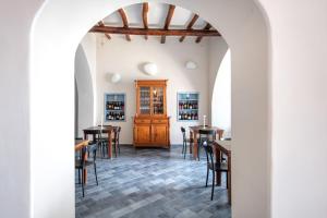a dining room with tables and chairs and an archway at Da Nino sul mare Filicudi in Filicudi +47 photos